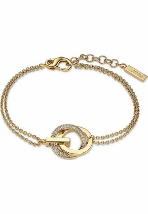 Gul kædearmbånd med to sammenkoblede cirkler. Den ene cirkel har en klar stenaccent. Armbåndet har en krokodillelås og en forlængerkæde.