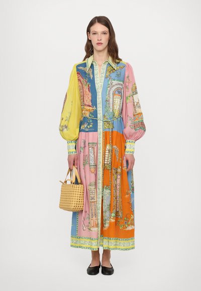 Multicolored long dress featuring a mix of floral and architectural prints, with puffed sleeves, a tie waist, and a contrasting collar.