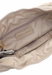 Beige interior of a handbag with a main compartment, a zippered pocket, and a leather tag labeled "EMILY & NOAH." Textured lining.