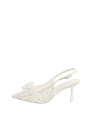 Zapato de tacón alto con tira trasera blanco, punta picuda, lados de malla adornados con pequeñas tachuelas y un lazo decorativo en la parte superior.