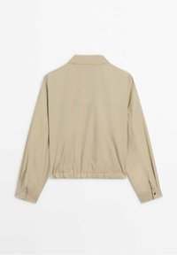 Beige, cropped long-sleeve jacket with a relaxed fit, featuring a collar, elastic waistband, and buttoned cuffs. Smooth fabric texture.