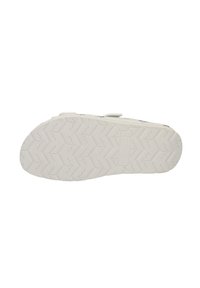 White casual shoe outsole with a zigzag tread pattern, featuring a smooth, textured surface and embossed brand logo.