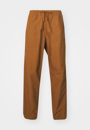 Brown, lightweight, drawstring trousers with an elastic waistband, featuring two side pockets and a smooth texture.
