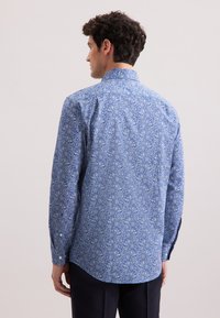 Camicia azzurra a fantasia floreale realizzata in tessuto leggero. Presenta un colletto button-down e maniche lunghe con orlo arrotondato e polsini con bottoni.