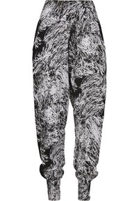 Pantalons de jogging amples à motifs abstraits en noir et blanc avec taille élastique et poignets, montrés de face sur fond uni.