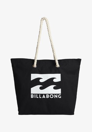 Sort lærredstote med hvid bølgelogo og "BILLABONG" tekst. Har tykke, snoede cremefarvede rebhåndtag og metaløjer.