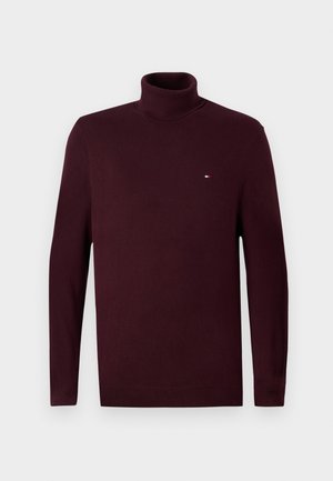 Burgundy turtleneck sweater, long sleeves, ribbed cuffs and hem, featuring a small logo on the chest, made from soft, textured fabric.