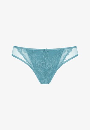 Lace thong in teal with floral patterns, sheer sides, and a satin bow accent in the center. Soft, lightweight fabric with detailed embroidery.