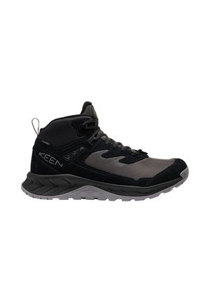 Schwarz-grauer Mid-Top-Wanderschuh mit profilierter Sohle, Schnürung vorne und Zuglasche an der Ferse, für den Außeneinsatz konzipiert.