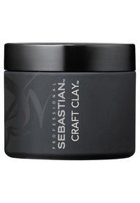 Zwarte ronde container van Sebastian Craft Clay, met een gladde matte afwerking, zilveren tekst en een zwart deksel met een minimalistisch merkontwerp.