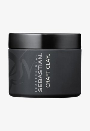 Zwarte ronde container van Sebastian Craft Clay, met een gladde matte afwerking, zilveren tekst en een zwart deksel met een minimalistisch merkontwerp.
