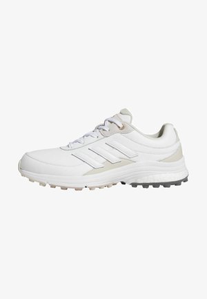 Scarpa atletica bianca con accenti beige, design con lacci, logo a tre strisce, lati testurizzati e suola in gomma con tacchette per trazione.