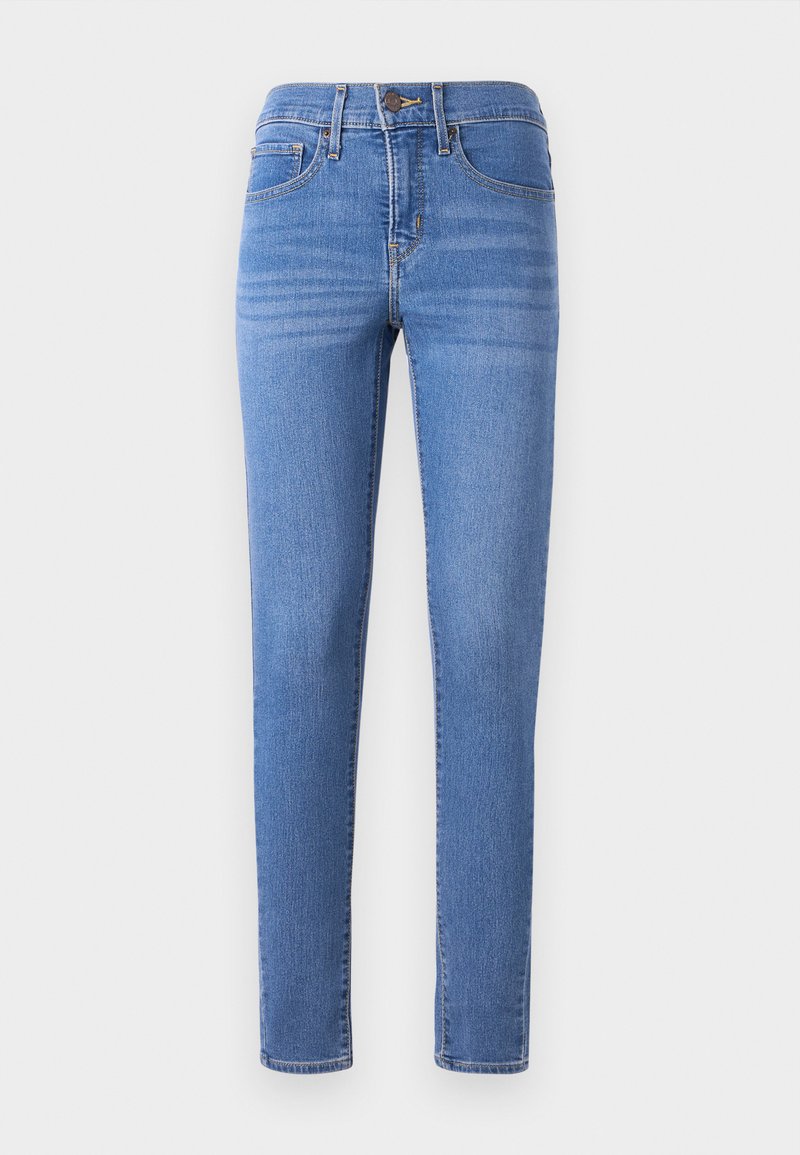 Jeans en denim bleu avec une coupe ajustée, braguette zippée et poches avant. Le tissu présente une texture lisse et un léger effet délavé.