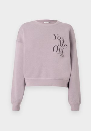 Light purple cropped sweatshirt with long sleeves. Features black text that reads "You Me Oui" and "All of the loves all of you."