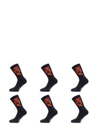 Chaussettes noires avec un logo "KTM" orange. Longueur mi-mollet, présentant une texture lisse et des talons renforcés. Six paires affichées en rang.