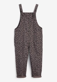 Salopette brune avec un motif léopard noir, bretelles ajustables, boutons sur les côtés et ourlets retroussés aux chevilles. En matière de coton.