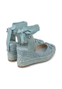 Sandali con zeppa in espadrilles blu, con un motivo intrecciato testurizzato, lacci alla caviglia e decorazioni in gemme trasparenti sulla parte superiore. Suola in gomma.