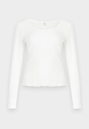 Λευκό τοπ μακρυμάνικο από ριμπ ύφασμα. Διαθέτει στρογγυλή λαιμόκοψη και ξέφτια στο τελείωμα, με εφαρμοστή γραμμή. Χωρίς εμφανές εξάρτημα.