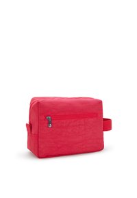 Borsa cosmetica in tessuto rosso con forma rettangolare, chiusura con zip e manico laterale. Presenta una superficie testurizzata e una piccola tasca frontale con zip.