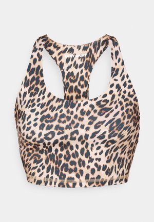 Leopard print sports bra featuring a racerback design. Made of smooth material with a stretch fit. Black and brown spots on a beige background.