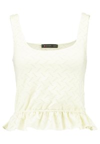 Valkoinen hihaton pusero, jossa on pepittahelma. Valmistettu teksturoidusta kankaasta, jossa on kalanruotokuvio ja koristeelliset rei'itykset. Sisäpuolella näkyvä merkki.