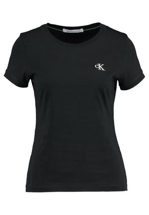 T-shirt noir à manches courtes en coton, avec un col rond et un petit logo "ck" blanc sur la poitrine gauche.