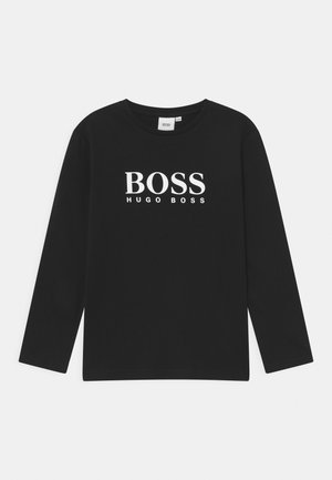 Schwarzes Langarm-T-Shirt aus Baumwolle mit einem auffälligen weißen Logo, das in fetter Schrift "BOSS HUGO BOSS" über die Brust geschrieben steht.