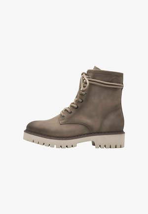 Brown leather ankle boots with a textured finish, featuring a rugged white sole, metal eyelets, and woven laces.
