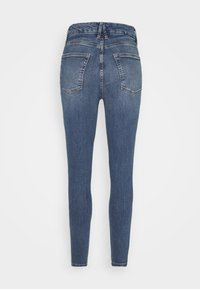 Tight jeans i mörkblå denim med hög elastisk midja, två bakfickor och en slät yta.