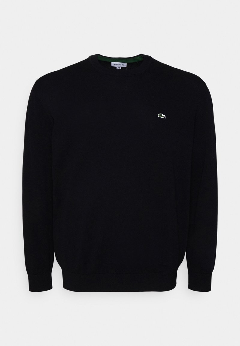 Pull noir à manches longues avec col rond et petit logo crocodile vert Lacoste sur la poitrine gauche.