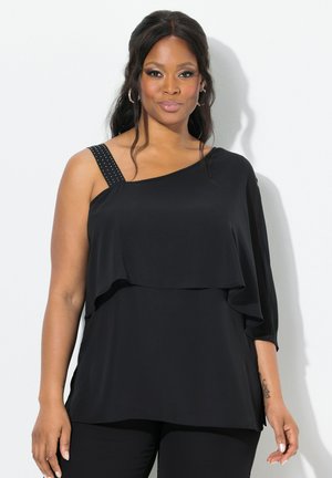Black top with asymmetric design, one shoulder, and layered fabric. Features a decorative, studded shoulder strap. Soft texture.