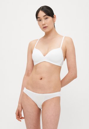 White bra and matching panties with a smooth, seamless design. The bra features adjustable straps and a V-neckline.