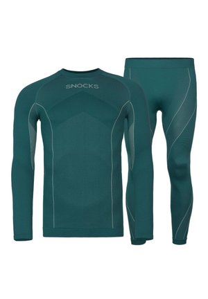 Set di top a maniche lunghe e leggings in teal con texture a coste, caratterizzato da cuciture accentuate grigie e il nome del marchio "SNOCKS" sul top.