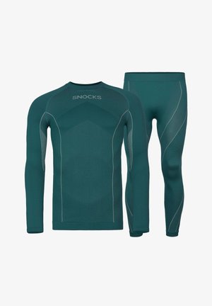 Set di top a maniche lunghe e leggings in teal con texture a coste, caratterizzato da cuciture accentuate grigie e il nome del marchio "SNOCKS" sul top.