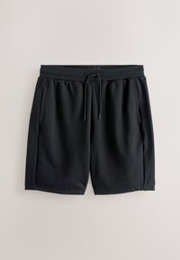 Shorts décontractés noirs avec taille élastique et cordon, poches avant et coupe ample, posés à plat sur un fond clair.