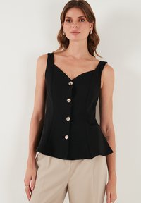 Schwarzes ärmelloses Peplum-Oberteil mit einem Herzausschnitt und fünf silbernen Knöpfen vorne, aus einem glatten, strukturierten Stoff.