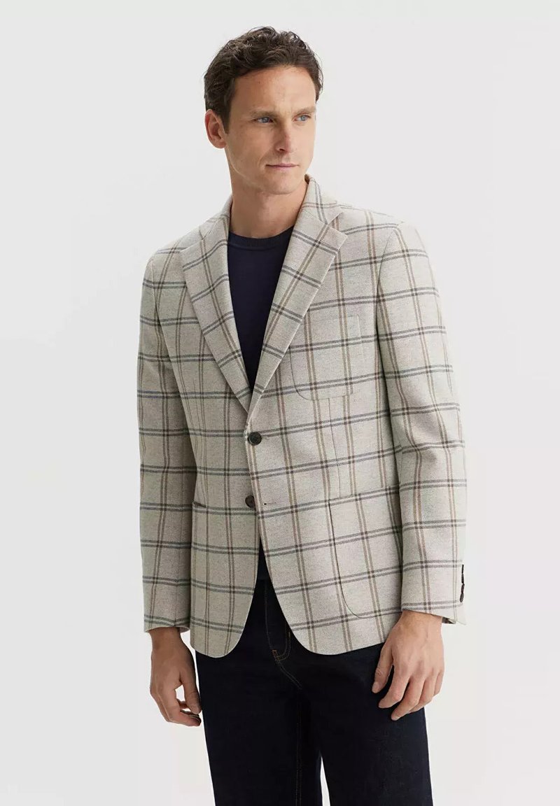 Jasnobeżowy żakiet w kratkę w odcieniach szarości i zieleni. Klapy z wycięciem, zapięcie na dwa guziki oraz jedna kieszeń na piersi. Teksturowana tkanina.