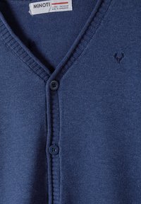 Navy blue cardigan with a v-neck, ribbed trim, and two blue buttons. Features a small embroidered design on the left side. Made of soft material.