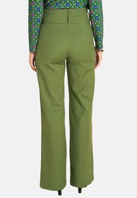 Green wide-leg pants with a high waist, featuring smooth fabric, tailored seams, and a clean hem. Back view shows waistband detail.