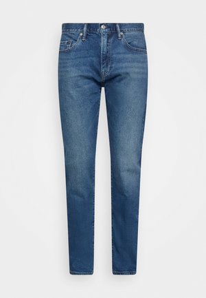 Jeans in denim blu con una vestibilità dritta, dotati di cinque tasche, chiusura anteriore con bottone e una finitura leggermente sbiadita.