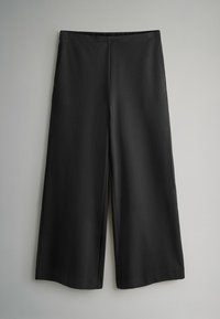 Melni platmalu bikses ar gludu tekstūru, kas aprīkotas ar elastīgu jostu un vienkāršu, minimālistisku dizainu.