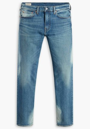 Blaue, ausgewaschene Slim-Fit-Jeans mit fünf Taschen und Knopfverschluss, die dezente Abnutzungen und leicht verwaschene Stellen an Oberschenkeln und Knien aufweisen.