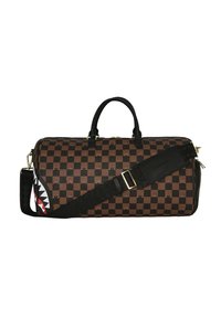 Bolsa de viaje a cuadros marrones con acentos negros, que cuenta con asas dobles y una correa desmontable. Incluye un diseño de tiburón en un lado.