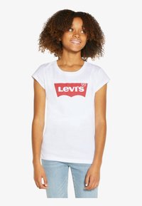 White short-sleeve t-shirt with a red Levi's logo on the front. The material appears soft and breathable, suitable for casual wear.