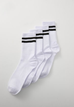White cotton socks with ribbed texture, featuring two black horizontal stripes at the top. Pack of four.
