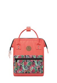 Coral backpack with a top handle, featuring a front pocket with a colorful tropical leaf pattern and a zip closure. Textured fabric.