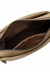 Tan leather bag with a textured finish and a zipper closure. Interior features a brown lining and multiple pockets for organization.