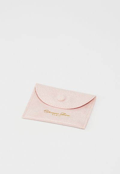 Pink suede cardholder with rounded flap, secured by a snap button. Features gold embossed text on the front. Soft texture, compact design.