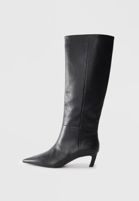 Black leather knee-high boot with a pointed toe, structured design, and a modest heel. Smooth texture, minimal stitching details.