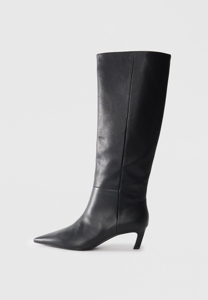 Black leather knee-high boot with a pointed toe, structured design, and a modest heel. Smooth texture, minimal stitching details.